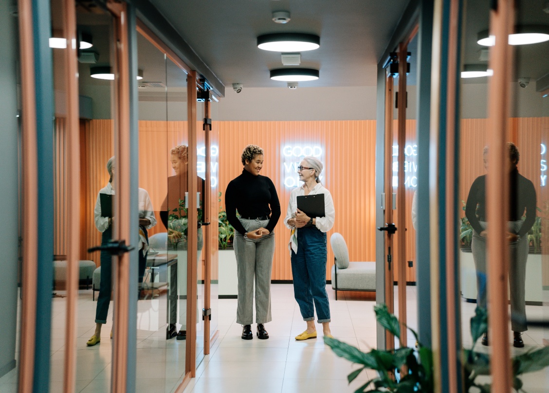 Stock photo of two people walking down a hall